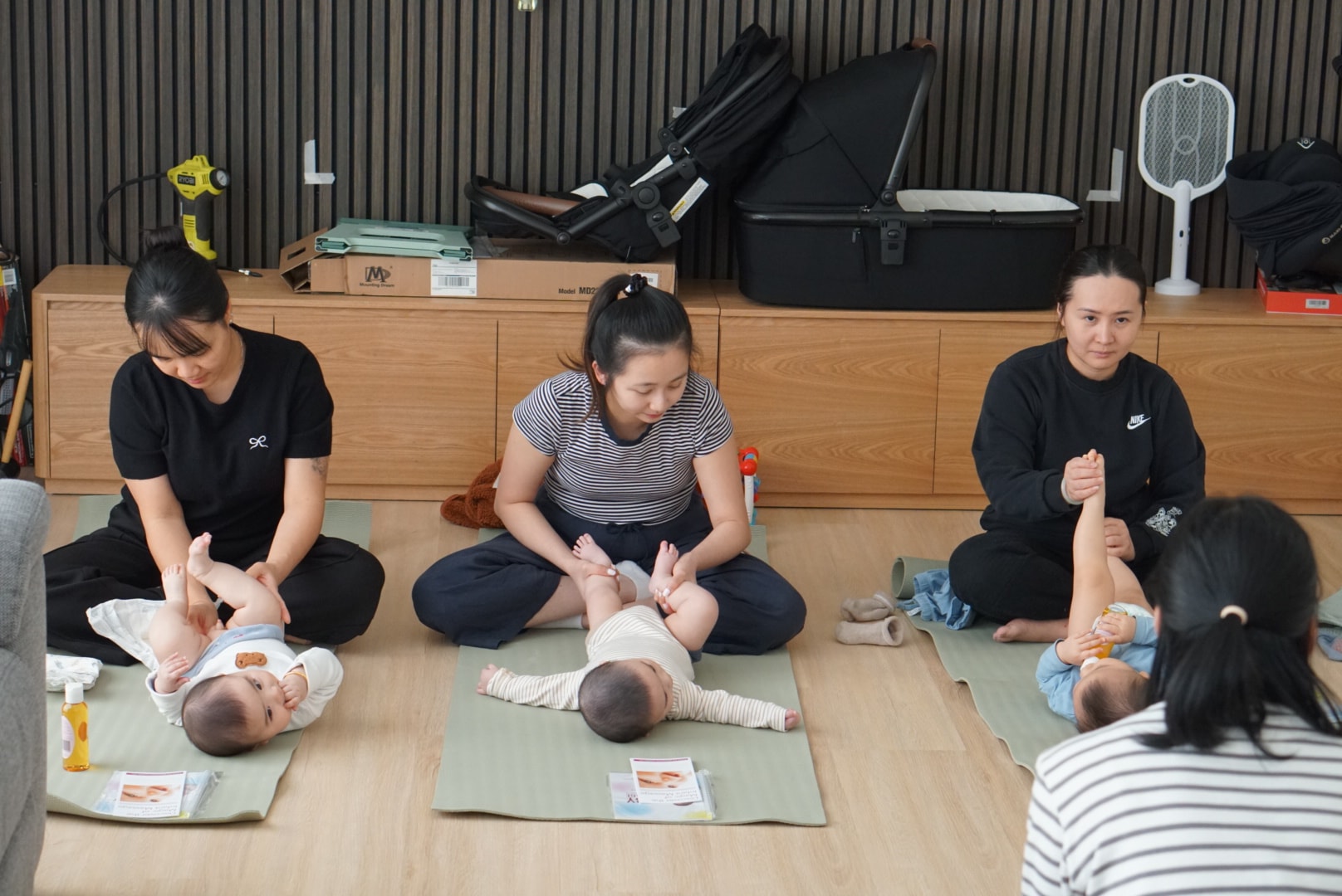 Lu teaching a baby massage group class in Melbourne