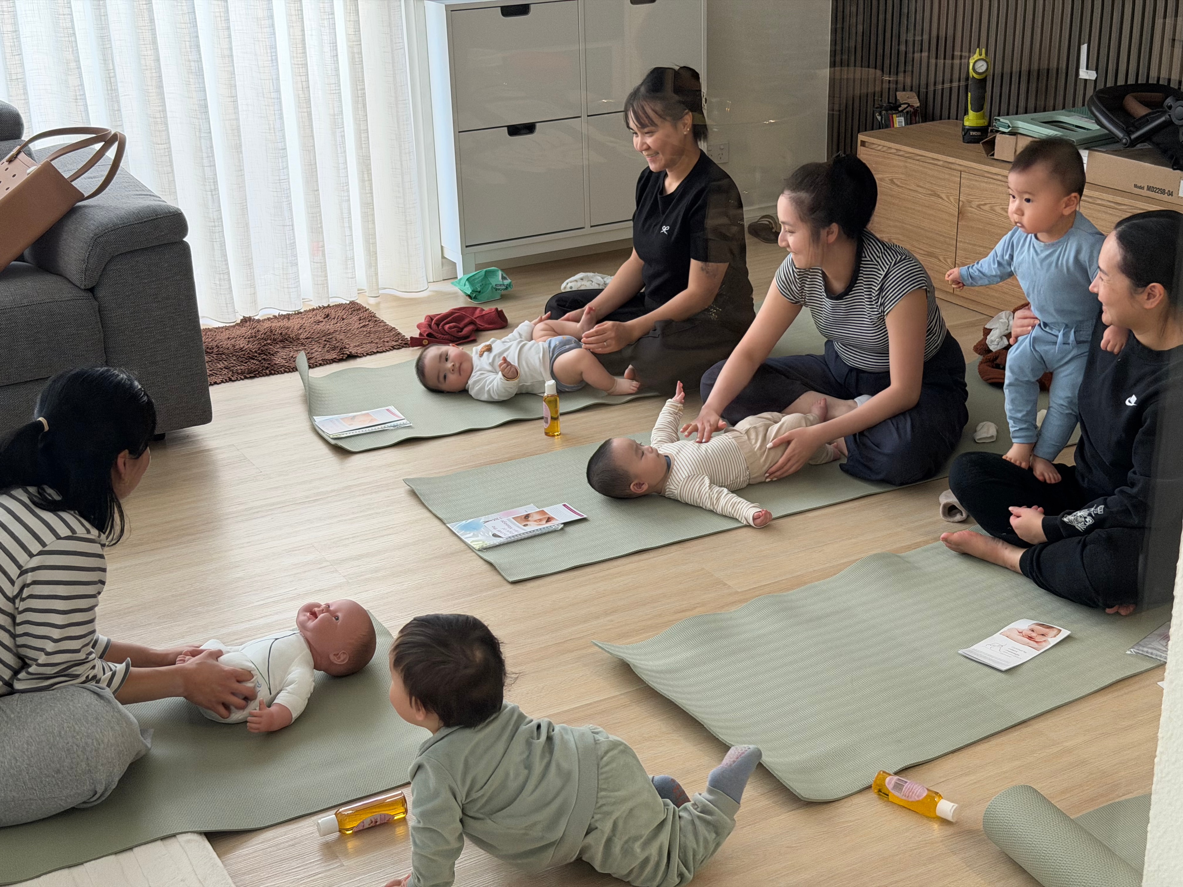 Group baby massage class with mothers and babies